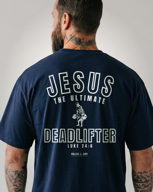 Jesus The Ultimate Deadlifter heavyweight tee, Navy, 6 oz Ultra Cotton boxy classic cut, plain front and collegiate JESUS THE ULTIMATE DEADLIFTER back print, Luke 24:6