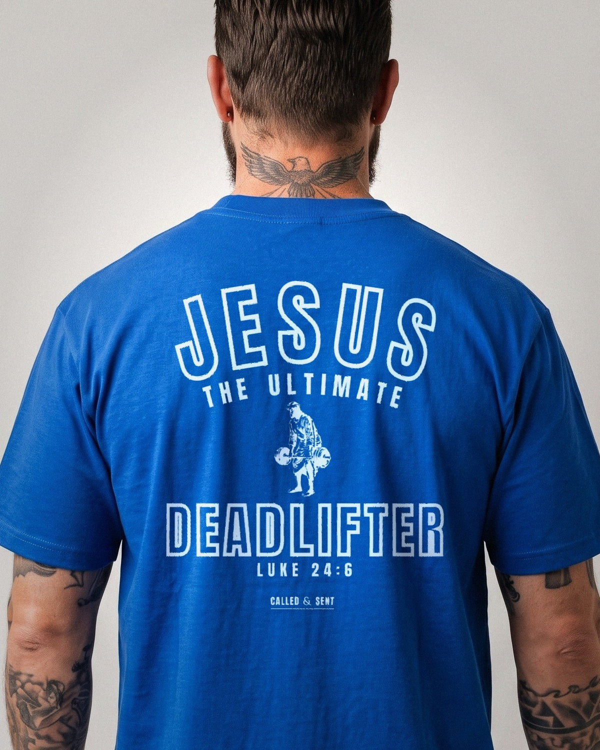 Jesus The Ultimate Deadlifter heavyweight tee, Royal Blue, 6 oz Ultra Cotton boxy classic cut, plain front and white ink JESUS THE ULTIMATE DEADLIFTER back print, Luke 24:6