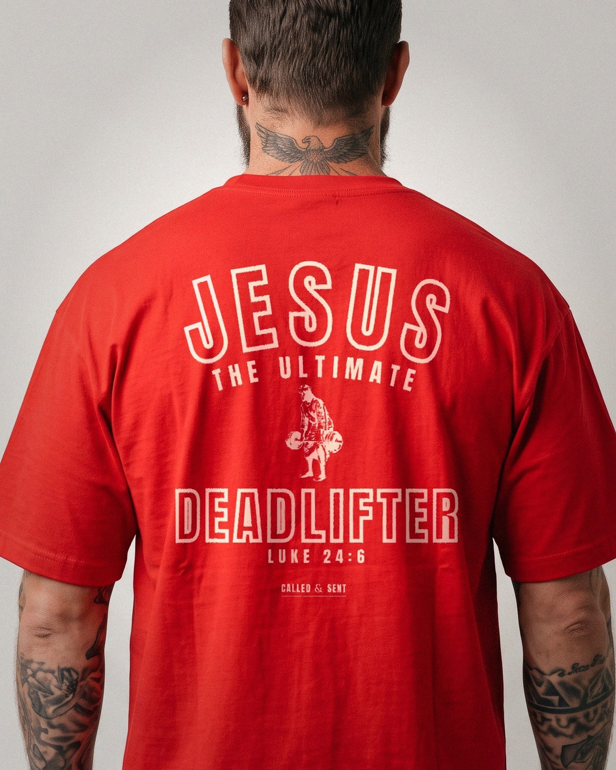 Jesus The Ultimate Deadlifter heavyweight tee, Red, 6 oz Ultra Cotton boxy classic cut, plain front and collegiate JESUS THE ULTIMATE DEADLIFTER back print, Luke 24:6
